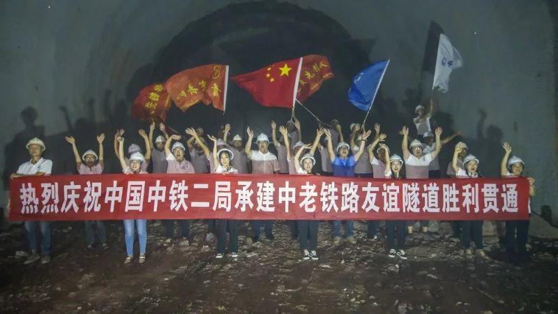 Engineers and workers celebrate the completion of the Friendship Tunnel on the China-Laos Railway.